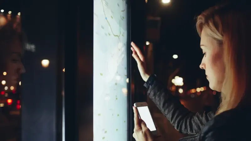 A woman using a digital kiosk