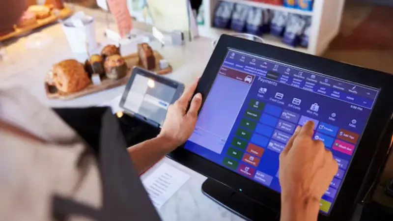 Store owner using a POS system to streamline operations