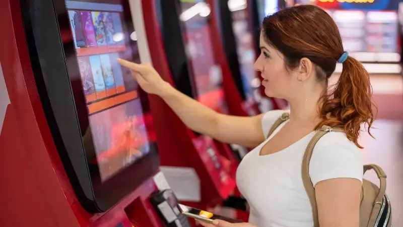 A Woman Buying Cinema Ticket at Self-Service Box Offce