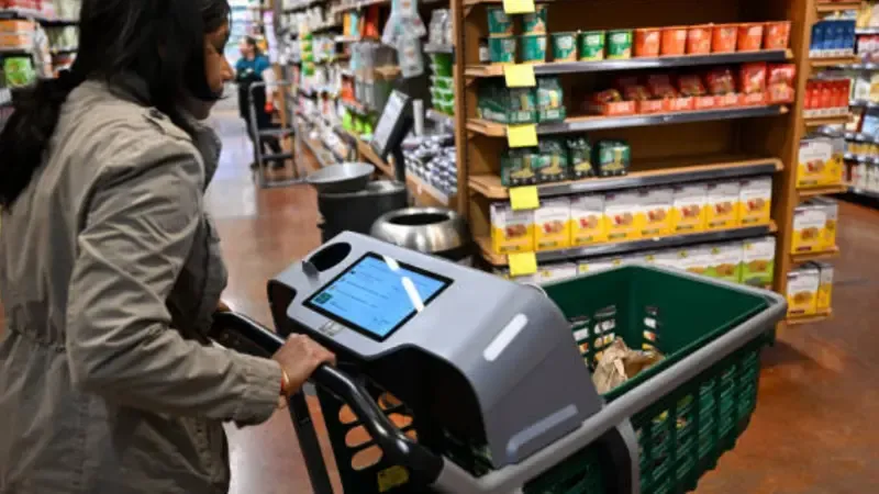 A customer using a smart cart in a supermarket