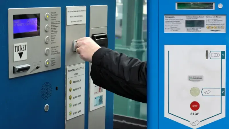 A driver paying at a parking machine