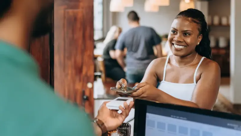 A retail shop owner receiving NFC payment
