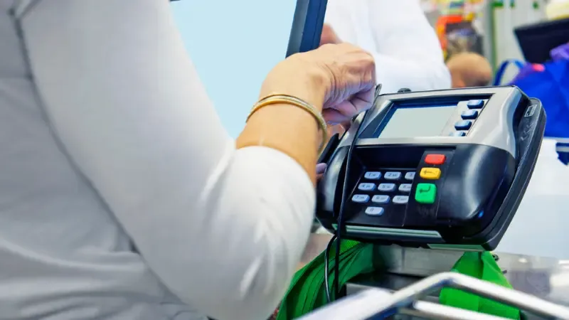 Business owner using traditional cash register