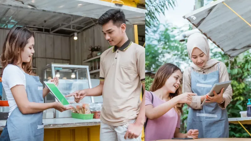 Customers ordering on a self-service kiosk in a restaurant