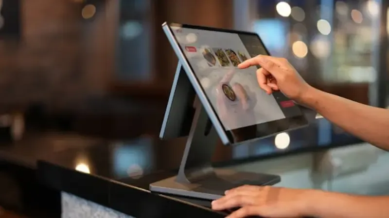 a person using a point-of-sale kiosk