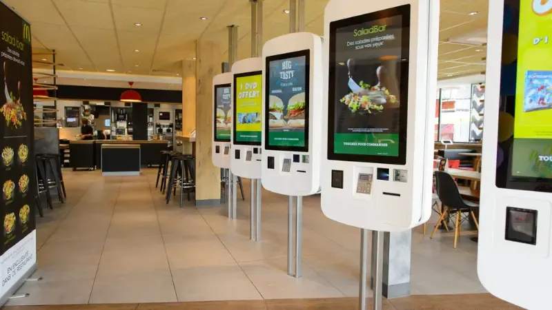 multiple self-ordering kiosks in MacDonalds