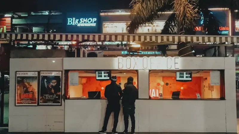 people buying movie tickets from the box office