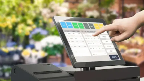A customer using POS hardware at a grocery shop