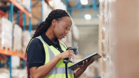 A user verifying item prices on a price checker