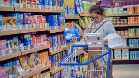 Shopper Navigating Store With Smart Cart