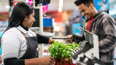 Staff member helping customer on checkout