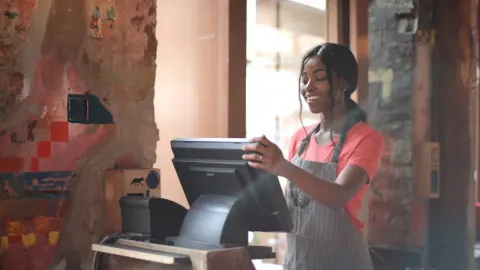 Young female working on cash register
