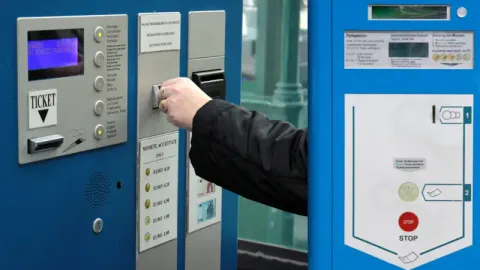 A driver paying at a parking machine