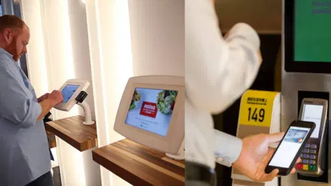 An elderly customer using a kiosk