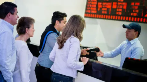 People buying tickets at the cinema