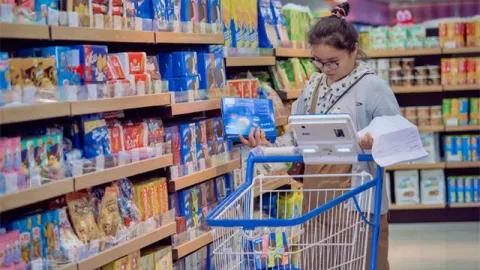 Shopper Navigating Store With Smart Cart