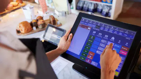 Store owner using a POS system to streamline operations