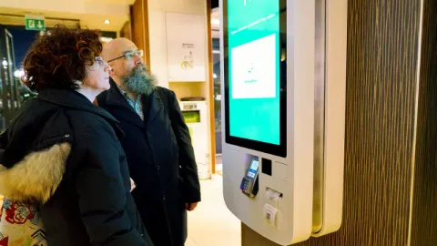 a couple using a self-service kiosk